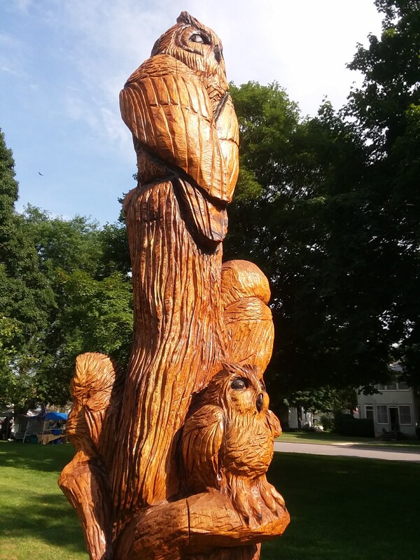 owls carved into a standing dead tree